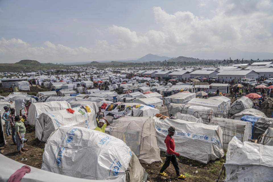 People displaced by the ongoing fighting between Congolese forces and M23 rebels gather in a camp on the outskirts of Goma, Democratic Republic of Congo, Wednesday, March 13, 2024, as OCHA (United Nations Office for the Coordination of Humanitarian Affairs) head and representative Ramesh Rajasingham, carries out a working visit to the region. (AP Photo/Moses Sawasawa)