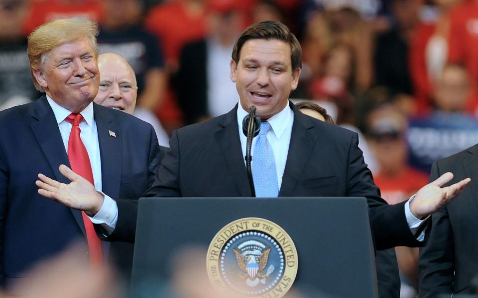 Donald Trump looks on as Florida Governor Ron DeSantis speaks in 2019 - Paul Hennessy/SOPA Images/LightRocket via Getty Images