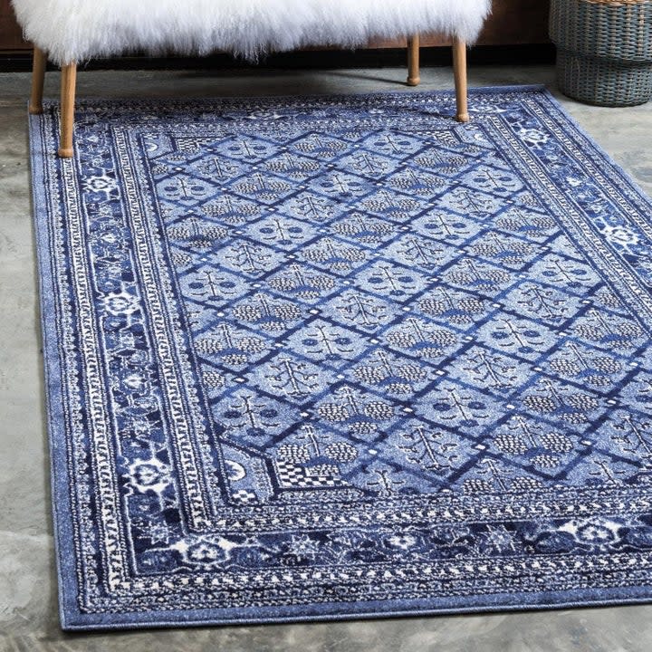 the rug with an intricate pattern and ivory and blue colors