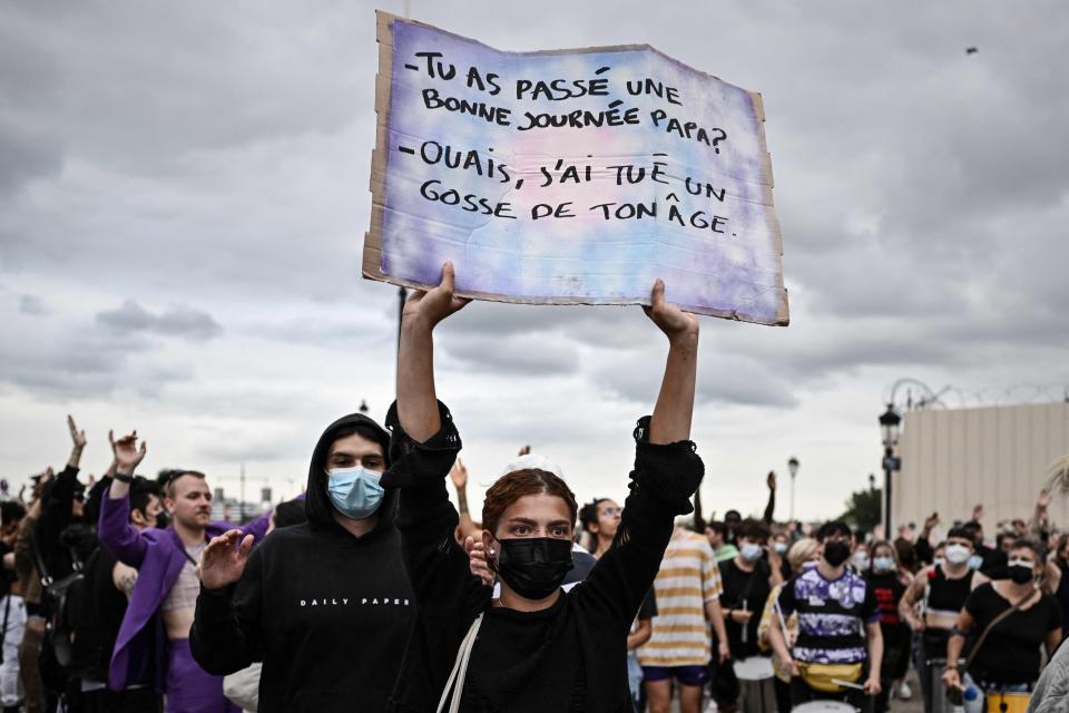 A protester holds a placard reading 