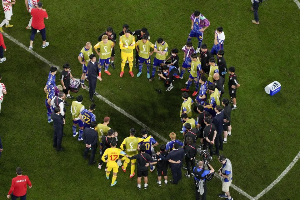 Japan's head coach Hajime Moriyasu speaks to members of team at the end of the World Cup round of 16 soccer match between Japan and Croatia at the Al Janoub Stadium in Al Wakrah, Qatar, Monday, Dec. 5, 2022. (AP Photo/Hassan Ammar)