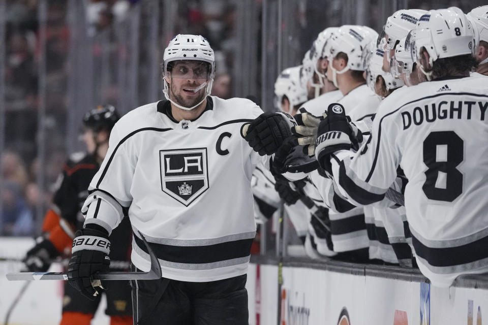 Los Angeles Kings center Anze Kopitar (11) is congratulated for his goal against the Anaheim Ducks during the first period of an NHL hockey game in Anaheim, Calif., Thursday, April 13, 2023. (AP Photo/Ashley Landis)