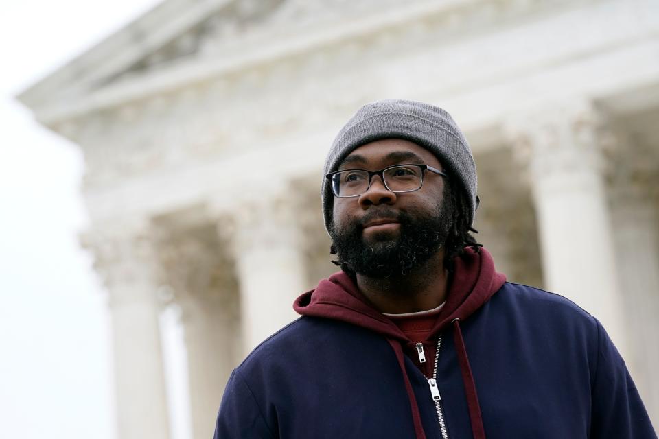 Evan Milligan, plaintiff in Merrill v. Milligan, an Alabama redistricting case, listens to a reporter's question following oral arguments outside the Supreme Court on Capitol Hill in Washington, Oct. 4, 2022.