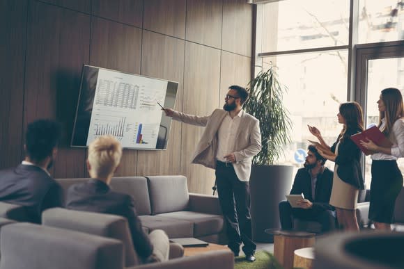 Businesspeople watching a presentation on a large screen