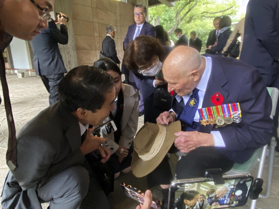 Richard Day, 97, right, a British army veteran who survived the Burma Campaign, one of the harshest battles in the World War II, talks to Yukihiro Torikai, left, a Tokai University humanities professor whose late grandfather also fought in the campaign, during a memorial at the Chidorigafuchi National Cemetery in Tokyo, Monday, Oct. 9, 2023. The memorial was attended by military officials from the embassies of several former allied nations, including Australia, Britain, New Zealand and the U.S. at the cemetery for the unknown Japanese who died overseas during the war. (AP Photo/Mari Yamaguchi)