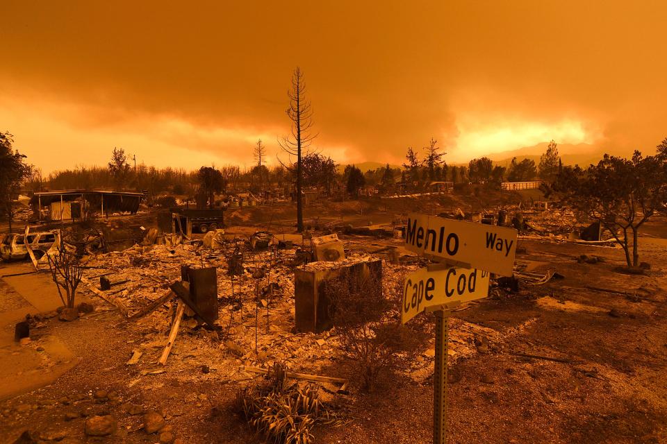 In this July 27 photo, homes leveled by the Carr Fire line the Lake Keswick Estates area of Redding. California lawmakers are abandoning a controversial proposal by Gov. Jerry Brown to shield electrical utilities from some financial liability for wildfires.
