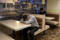 A man sleeps at a 24-hour McDonald's restaurant in Hong Kong, China November 11, 2015. A large number of homeless people sleeping on the street has long been been a problem in Hong Kong mainly due to its high rents and soaring property prices. In recent years, the opening of McDonald's 24-hour fast food restaurants all over the city have become popular alternatives for homeless people known as McRefugees or McSleepers to spend the night in a safer and more comfortable way than on the street. McDonaldâ€™s Hong Kong said in a statement that it is accommodating to people staying long in the restaurant for their own respective reasons, while striking a good balance to ensure that customers enjoy their dining experience. REUTERS/Tyrone Siu