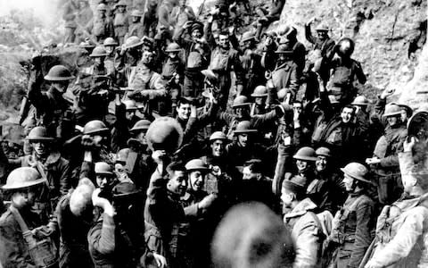  American troops cheer after hearing the news that the Armistice had been signed, meanwhile hundreds of solider continued to die on that day - Credit: AP