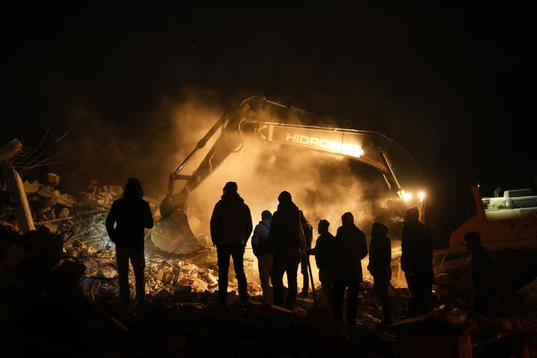 Equipos de rescate y otras personas buscan a víctimas en edificios destruidos por un terremoto, el miércoles 8 de febrero de 2023, en Elbistan, en el sur de Turquía. (AP Foto/Francisco Seco)