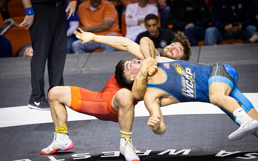 Grand View's Ben Provisor, red, turns Spencer Woods in a head pinch during their Greco-Roman Final X match in Stillwater on Friday. Provisor won the match, 8-0.