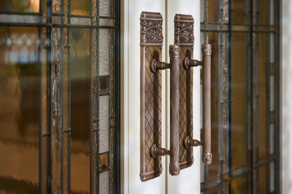 Metal handles and stained glass inserts on the Orem Utah Temple entrance door.  