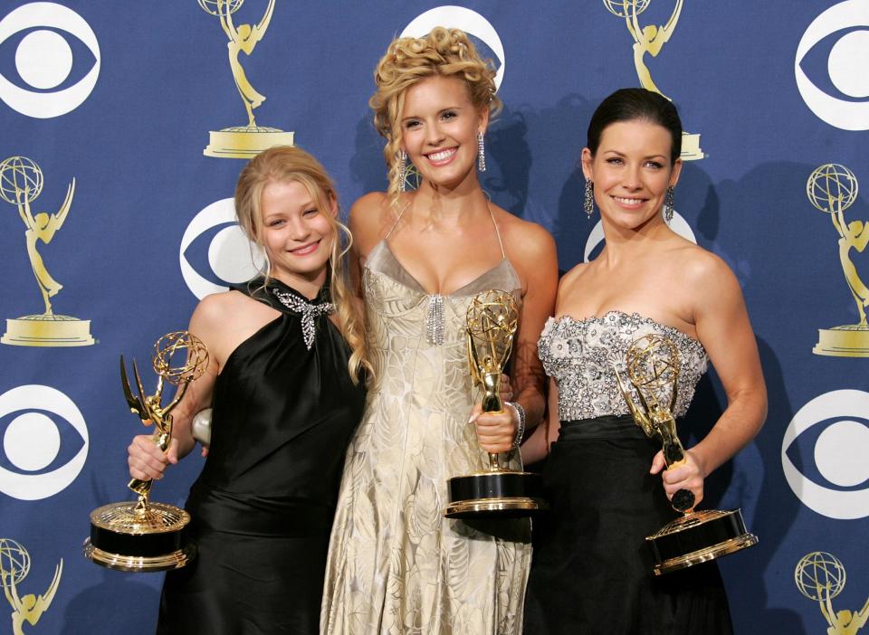 From left to right: Emilie de Ravin, Maggie Grace and Evangeline Lilly holding Emmys at the 2005 awards (Getty Images)