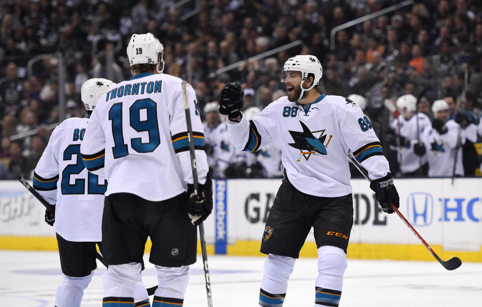 San Jose Sharks right wing Brent Burns, right, celebrates his goal with teammates defenseman Dan Boyle, left, and center Joe Thornton during the first period in Game 3 of an NHL hockey first-round playoff series , Tuesday, April 22, 2014, in Los Angeles. (AP Photo/Mark J. Terrill)