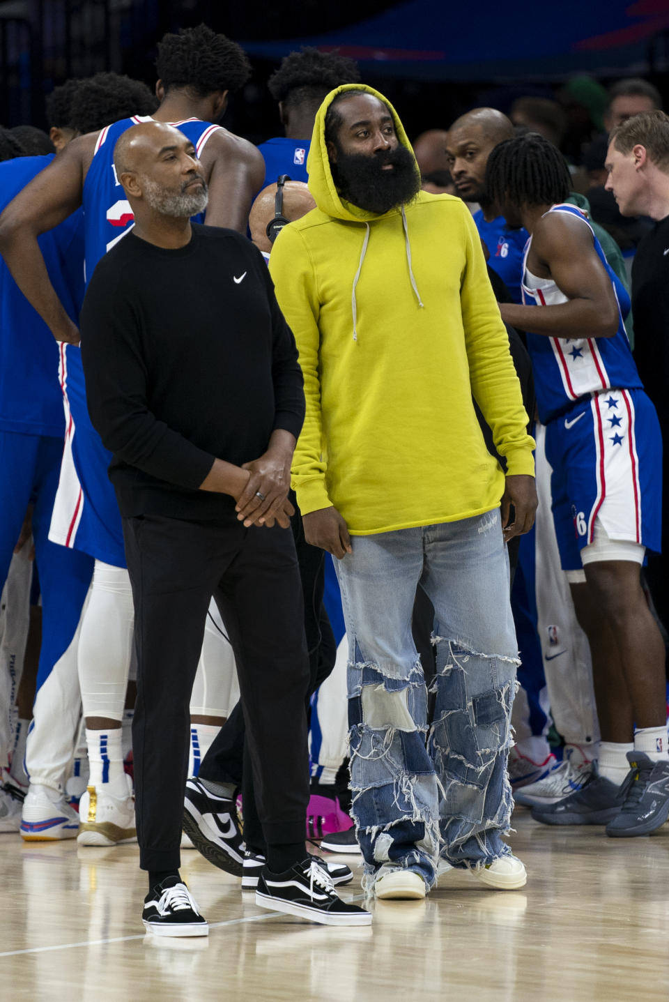 Philadelphia 76ers' James Harden, right, looks on with assistant coach Bobby Jackson, left, during the first half of an NBA basketball game against the Portland Trail Blazers, Sunday, Oct. 29, 2023, in Philadelphia. (AP Photo/Chris Szagola)