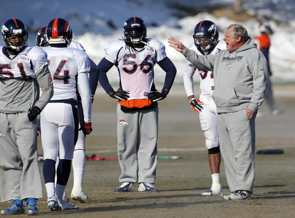 Denver Broncos linebackers coach Richard Smith, right, instructs his players during NFL football practice at the team's training facility in Englewood, Colo., on Thursday, Jan. 23, 2014. The Broncos are scheduled to play the Seattle Seahawks in Super Bowl XLVIII on Feb. 2. (AP Photo/Ed Andrieski)