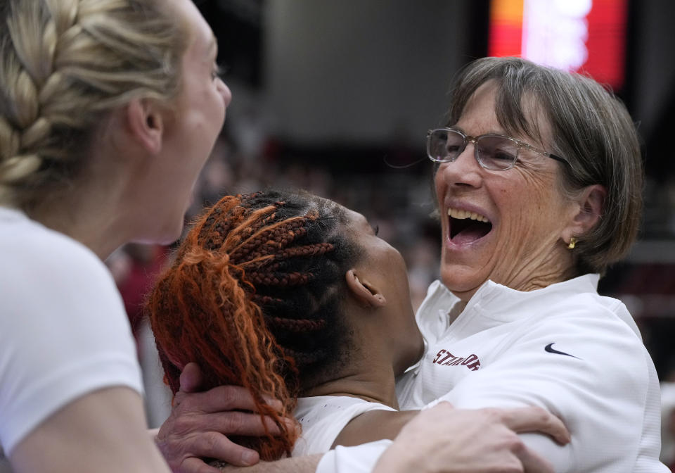 Stanford coach Tara VanDerveer, right, celebrates with Kiki Iriafen, center, and Cameron Brink, left, after the team's victory against Oregon in an NCAA college basketball game Friday, Jan. 19, 2024, in Stanford, Calif. VanDerveer tied former Duke men's basketball coach Mike Krzyzewski for the most wins as a college basketball coach. (AP Photo/Tony Avelar)