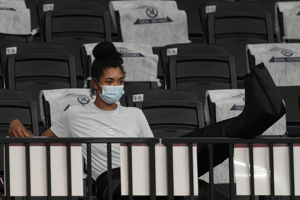 Injured United States' Jordan Thompson watches her team from the tribune during the women's volleyball preliminary round pool B match between United States and Italy at the 2020 Summer Olympics, Monday, Aug. 2, 2021, in Tokyo, Japan. (AP Photo/Frank Augstein)