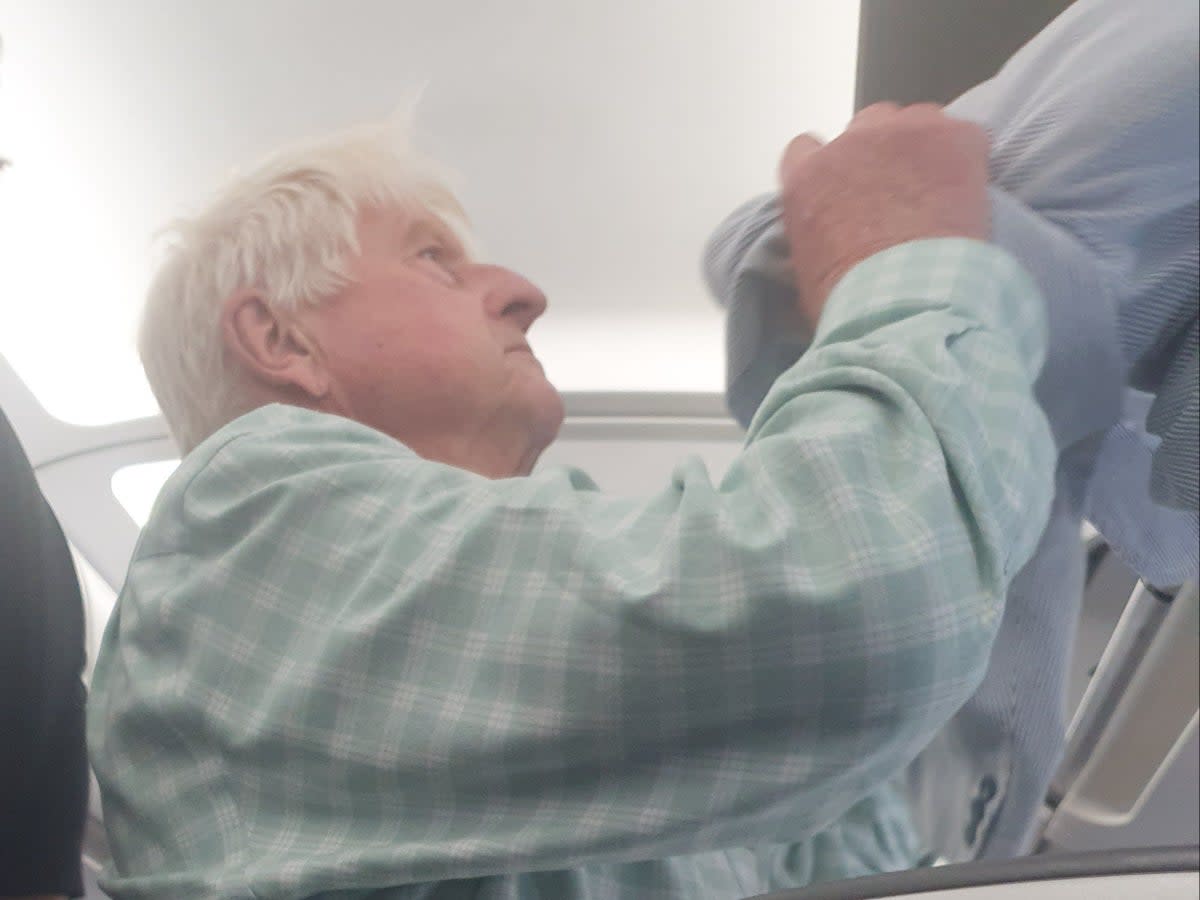 Departing soon: Stanley Johnson preparing to leave British Airways flight 2461 from Malaga, which was diverted to Heathrow (Richard Davenport)