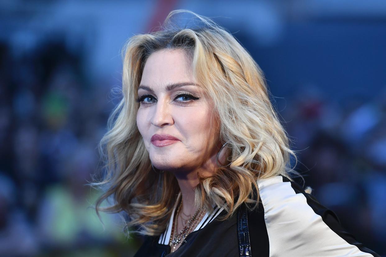 US singer-songwriter Madonna poses arriving on the carpet to attend a special screening of the film 