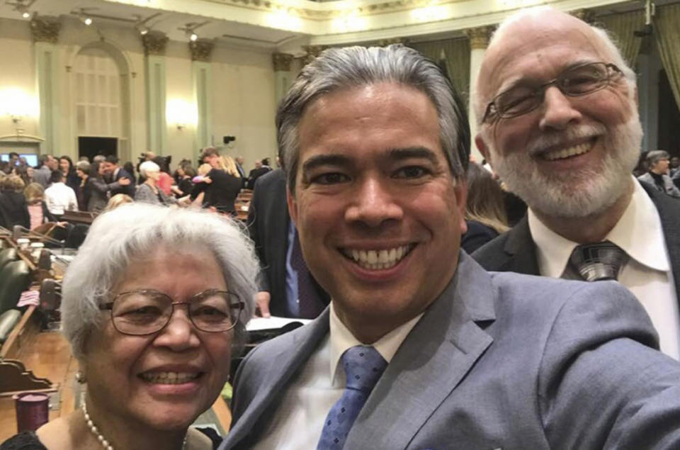 In this image provided by the Office of Assemblyman Rob Bonta, he is seen in a selfie with his parents, Warren and Cynthia Bonta, after a swearing-in session at the State Capitol in Sacramento, Calif., on Dec. 3, 2018. Bonta, California Gov. Gavin Newsom's nominee for attorney general, grew up in the farm workers movement of the 1970s. His parents worked alongside legendary labor leaders Cesar Chavez and Dolores Huerta. His mother came to the United States in 1965 from the Philippines. His father marched with Dr. Martin Luther King Jr. in Selma, Ala. Bonta would be the first Filipino American to be California's attorney general if he is confirmed by the state Legislature. (Office of Assemblyman Rob Bonta via AP)
