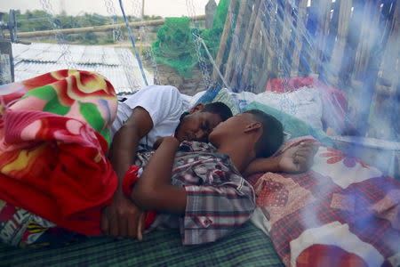 A Muslim family, whose home was burnt in 2013 during anti-Muslim violence and unrest, sleep at their temporary shelter at Thiriminglar quarter in Meiktila May 15, 2015. REUTERS/Soe Zeya Tun