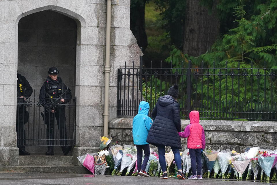 People lay flowers at the gates of Balmoral in Scotland following the death of Queen Elizabeth II on Thursday. Picture date: Friday September 9, 2022.