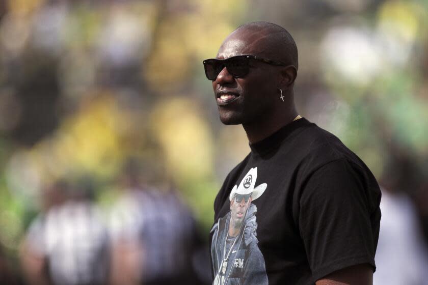 Former NFL football player Terrell Owens looks on during warm ups before an NCAA football game between Colorado and Oregon