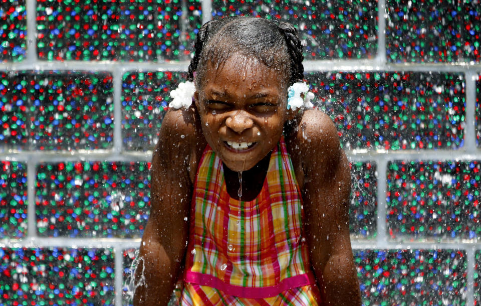 Kale Currin cools off in the Crown Fountain at Millennium Park in Chicago, Illinois, July 5, 2012. Jeff Haynes / Reuters