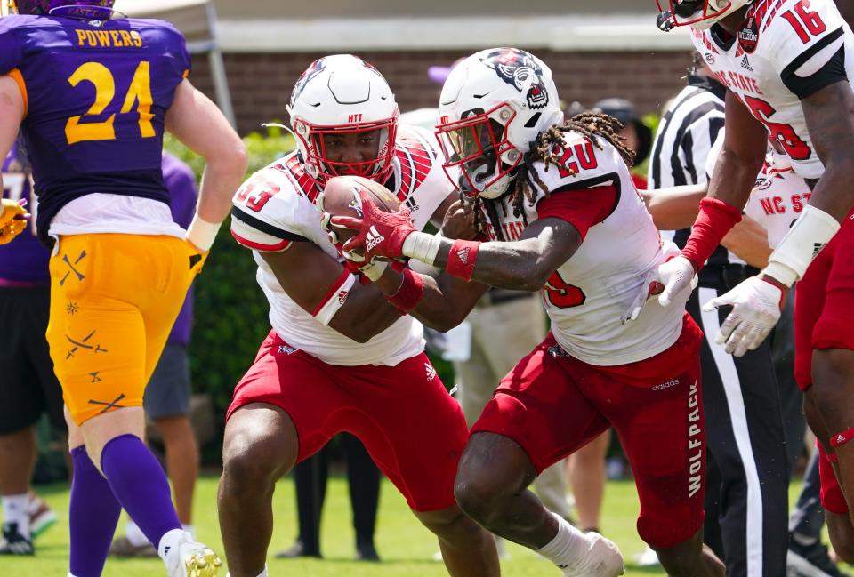 Sep 3, 2022; Greenville, North Carolina, USA;  North Carolina State Wolfpack safety Sean Brown (20) celebrates his touchdown on a blocked punt with North Carolina State Wolfpack linebacker Jordan Poole (33) during the first half at Dowdy-Ficklen Stadium. Mandatory Credit: James Guillory-USA TODAY Sports