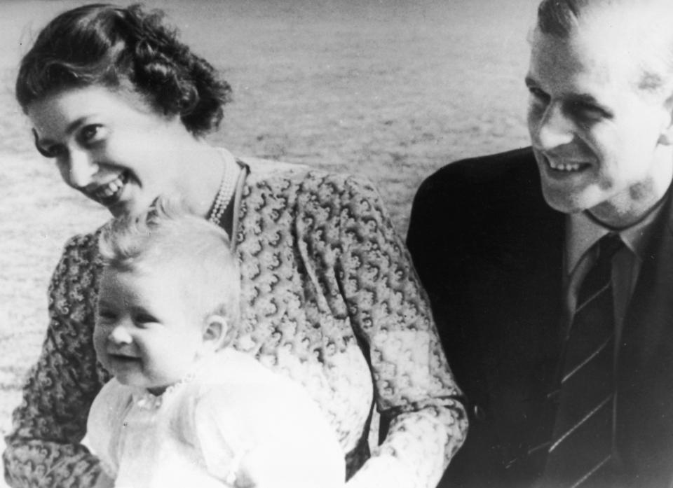 Princess Elizabeth and Prince Philip smile with Prince Charles on the grounds of Windlesham Moor in Surrey in July 1949.