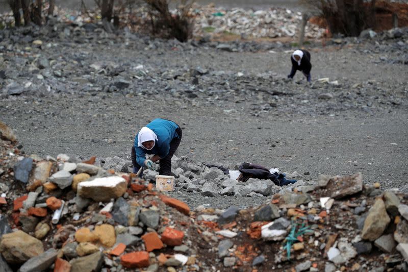 A woman searches for chrome from the scrap in Bulqiza