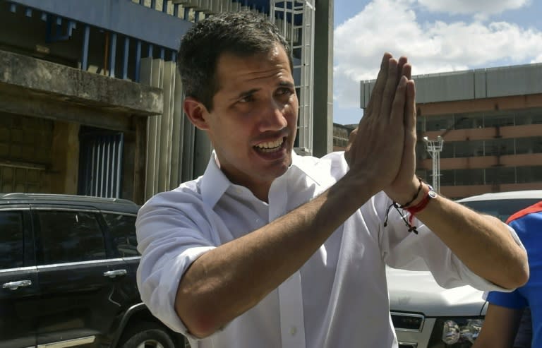 Venezuelan opposition leader and self-declared acting president Juan Guaido gestures to supporters at the end of a rally with volunteers