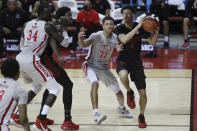 San Diego State's Trey Pulliam (4) drives to the rim against UNLV's Cheikh Mbacke Diong (34) and Nicquel Blake (22) during the second half of an NCAA college basketball game Wednesday, March 3, 2021, in Las Vegas. (AP Photo/Joe Buglewicz)