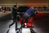 A shopper pushes a cart loaded with a TV outside a Target store in Newport, New Jersey November 27, 2014. Target opened on Thanksgiving evening at 6 pm, ahead of many other Black Friday retailers. REUTERS/Eduardo Munoz