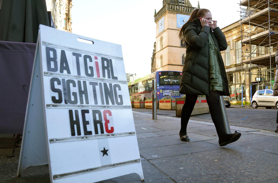 A member of the public passes a sign in Glasgow, near the film set of the new Batgirl movie