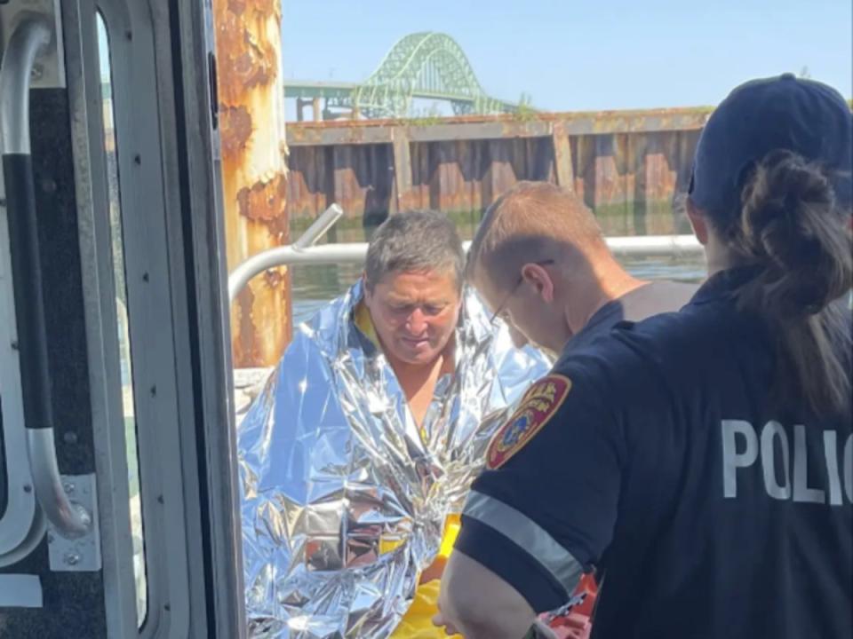 Police treat Dan Ho of Copiague, New York, who was swept out to sea on 1 August, 2023, and treaded water for five hours before rescued (Suffolk Police Department)