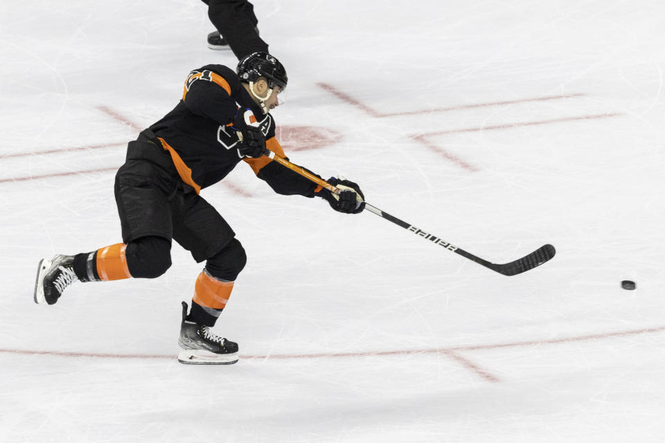 Philadelphia Flyers center Scott Laughton shoots on goal to score during the second period of an NHL hockey game against the Vancouver Canucks, Saturday, Oct. 15, 2022, in Philadelphia. (AP Photo/Laurence Kesterson)