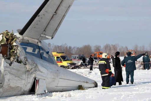 A photo provided on April 2, 2012 by the Russian Emergencies Ministry shows rescuers and investigators working at the site of a plane crash which killed 31 people on Monday. The French-Italian made ATR-72 passenger plane run by private Russian airline UTair came down moments after takeoff some 45 km (28 miles) from the western Siberian city of Tyumen