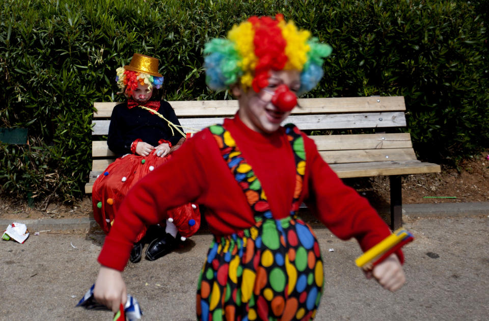 Two Ultra Orthodox Jewish boys dress as clowns during the Purim festival in the ultra-Orthodox town of Bnei Brak, Israel, Sunday, Feb. 24, 2013. (AP Photo/Ariel Schalit)