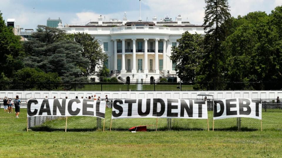 As college students around the country graduate with a massive amount of debt, advocates display a hand-painted sign on the Ellipse in front of The White House to call on President Joe Biden to sign an executive order to cancel student debt on June 15, 2021 in Washington, DC. (Photo by Paul Morigi/Getty Images for We The 45 Million)