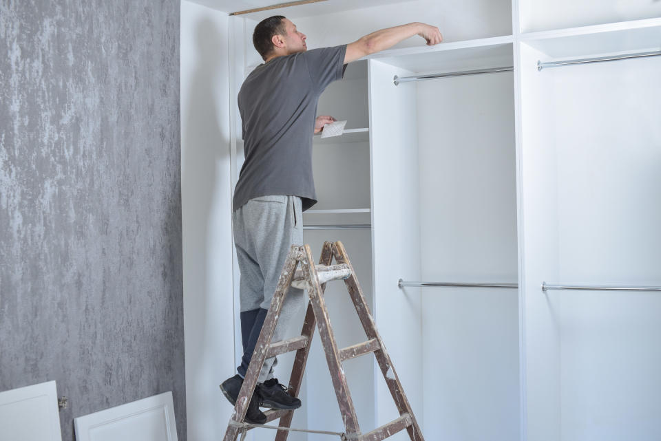 Man renovating a larger built-in closet system
