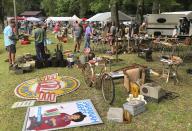 A crowd looks through items at the World's Longest Yard Sale, which stretches from Alabama to Michigan, at its southernmost point in Gadsden, Ala., on Thursday, Aug. 6, 2020. Promoters considered canceling the four-day sale because of the coronavirus pandemic but decided to go ahead with the event, now in its 34th year. (AP Photo/Jay Reeves)