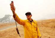 Firefighter Michael LoPresti from San Luis Obispo takes weather readings during the Soberanes Fire off of Rancho San Carlos near Carmel Valley, California, U.S. July 29, 2016. REUTERS/Michael Fiala