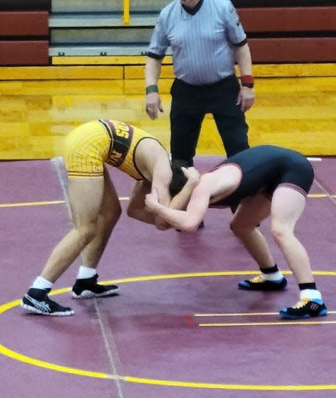 Bloomington North's Chase Hostetler (left) and Edgewood's Trenton Fender lock arms during their match at 182 pounds.
