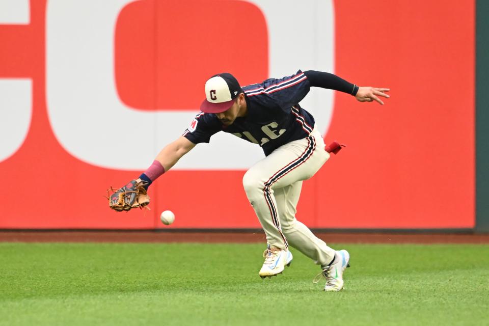 Guardians left fielder Steven Kwan can not get to a ball hit by Tigers left fielder Mark Canha during the third inning, July 22, 2024, in Cleveland.