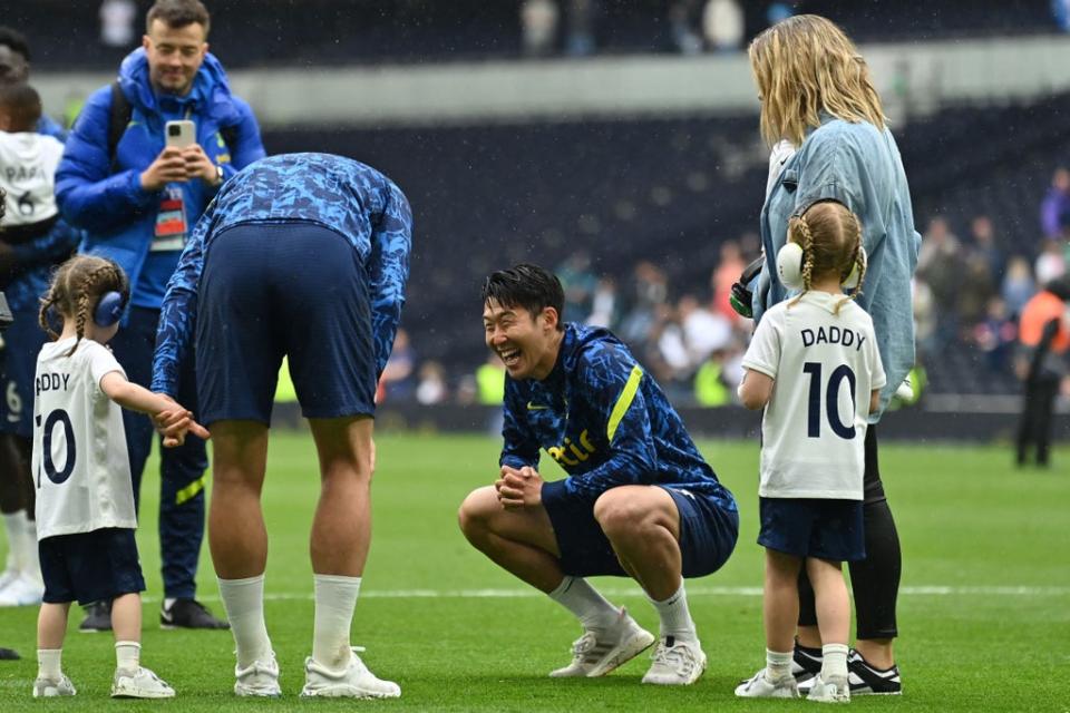 Son Heung-Min smiles as he chats with Harry Kane and his family (AFP via Getty Images)