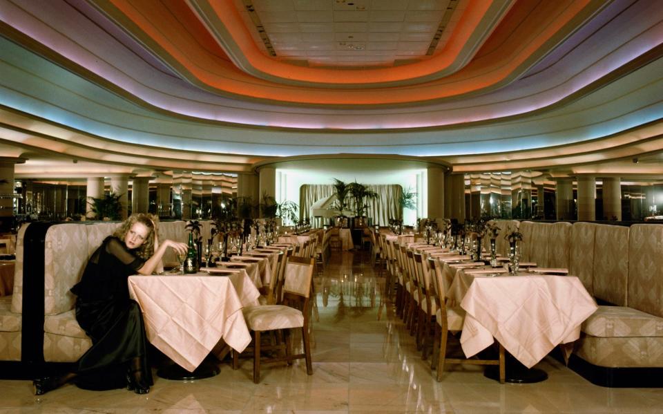 Twiggy sits alone in the Rainbow Room at Biba, 1971