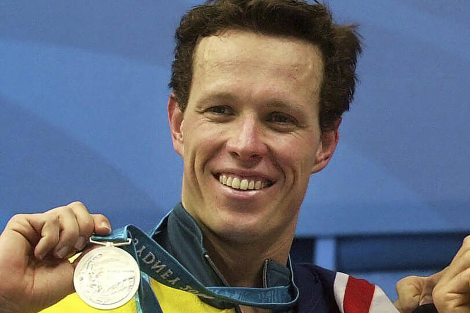 FILE - Australian silver medal winner for the men's 1500m freestyle Kieren Perkins stands on the podium Saturday, Sept. 23, 2000, at the Sydney International Aquatic Center during the Summer Olympics in Sydney. Two-time Olympic swimming gold medalist and Australian Sports Commission chief Kieren Perkins says “someone will die” if a multi-sport event that he called “borderline criminal” and which allows banned substances goes ahead.(AP Photo/David Longstreath, File)