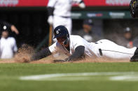 Detroit Tigers' Spencer Torkelson scores against the Minnesota Twins in the 11th inning during the first baseball game of a doubleheader, Saturday, April 13, 2024, in Detroit. (AP Photo/Paul Sancya)