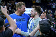 Dallas Mavericks guard Luka Doncic , right, embraces former Dallas Maverick Dirk Nowitzki after Game 7 of an NBA basketball Western Conference playoff semifinal against the Phoenix Suns, Sunday, May 15, 2022, in Phoenix. The Mavericks defeated the Suns 123-90. (AP Photo/Matt York)